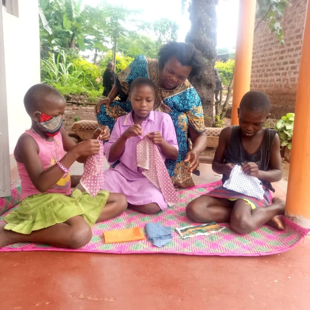 Girls learning a practical skill together on a mat